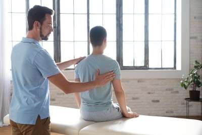 man helping patient physiotherapy