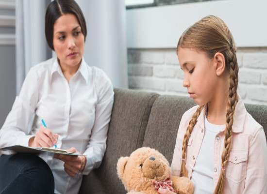 photo professional young psychologist trying to get through to girl with problems