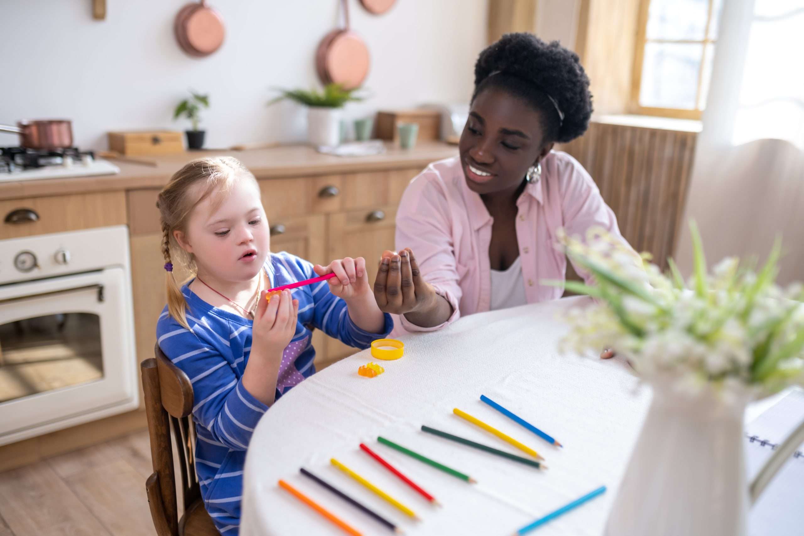 African american woman and a girl learning colors and drawing